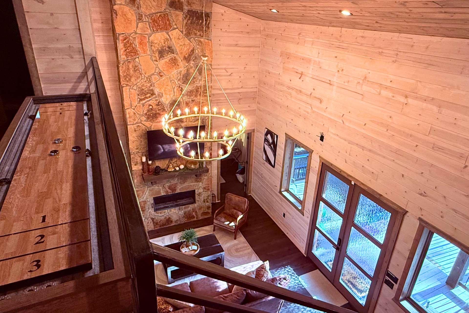 Cozy living room with stone fireplace & nature views