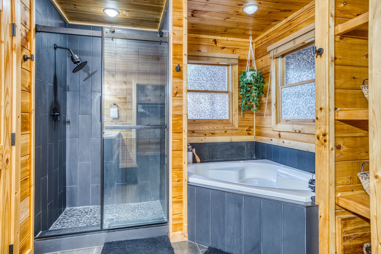 Main-level master bathroom includes double sinks, walk-in shower, jetted tub, separate toilet room, and walk-in closet.