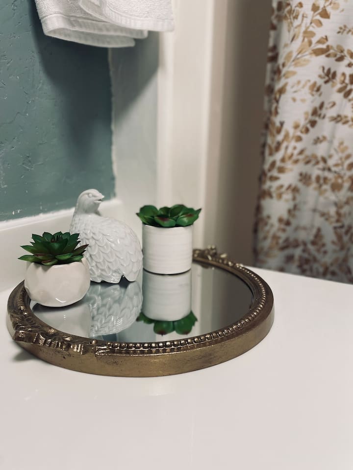 A delicate porcelain bird adds a touch of charm and character to the bathroom.