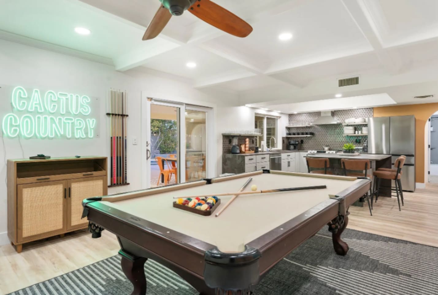 The "Cactus Country" neon sign gives this game room its own personality, with a well-stocked kitchen never far from the action.
