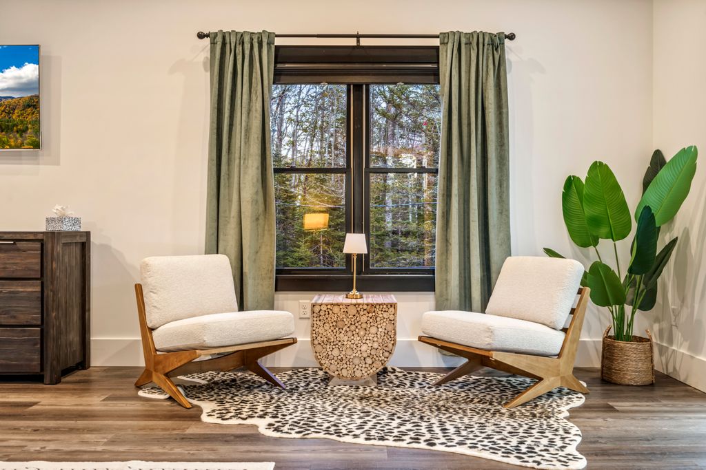 A cozy sitting area with natural light and forest views — ideal for morning coffee, reading, or simply soaking in the peaceful mountain atmosphere.