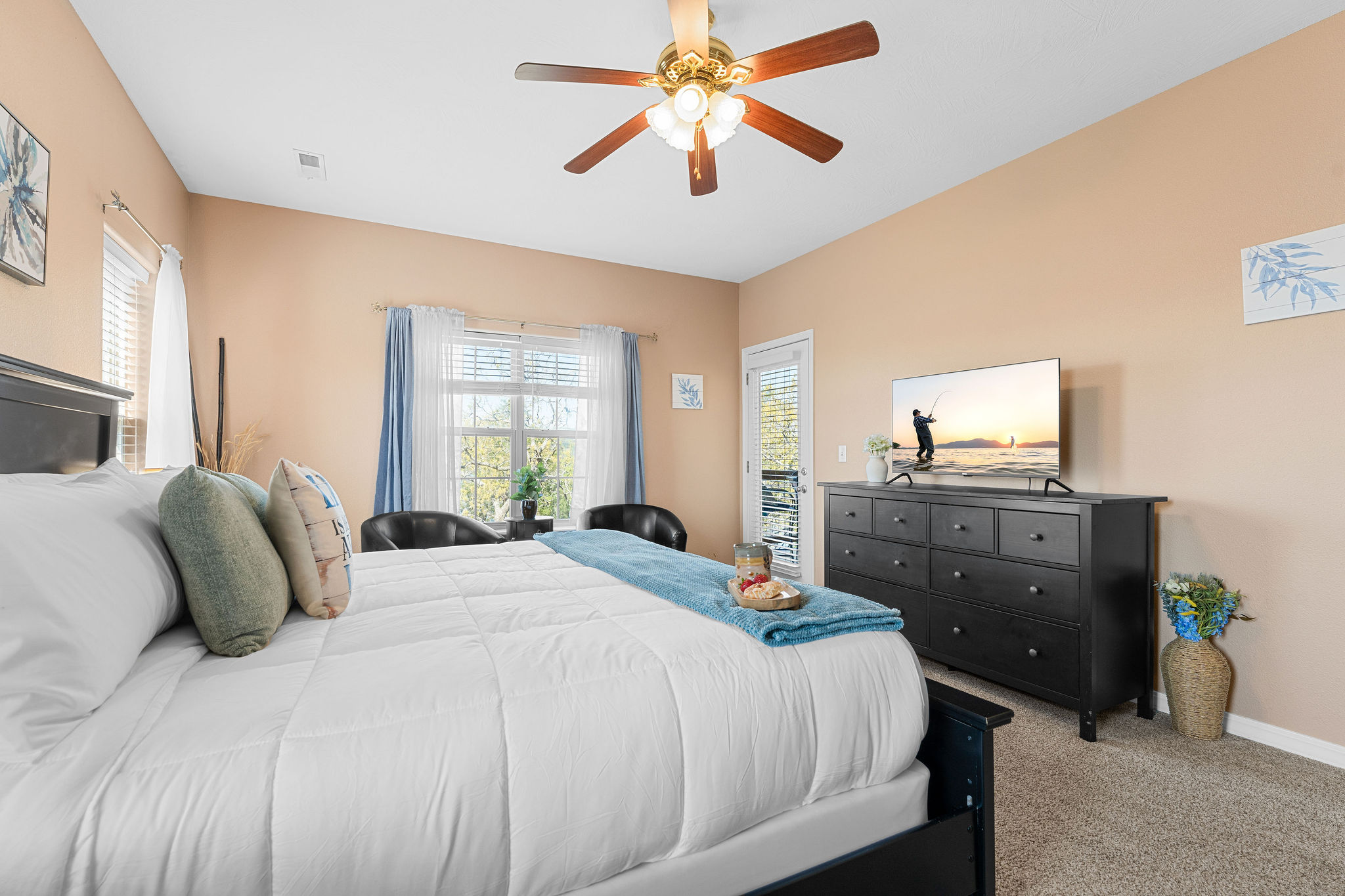 Spacious primary bedroom with king bed, large dresser, smart tv and walk out access to the deck.
