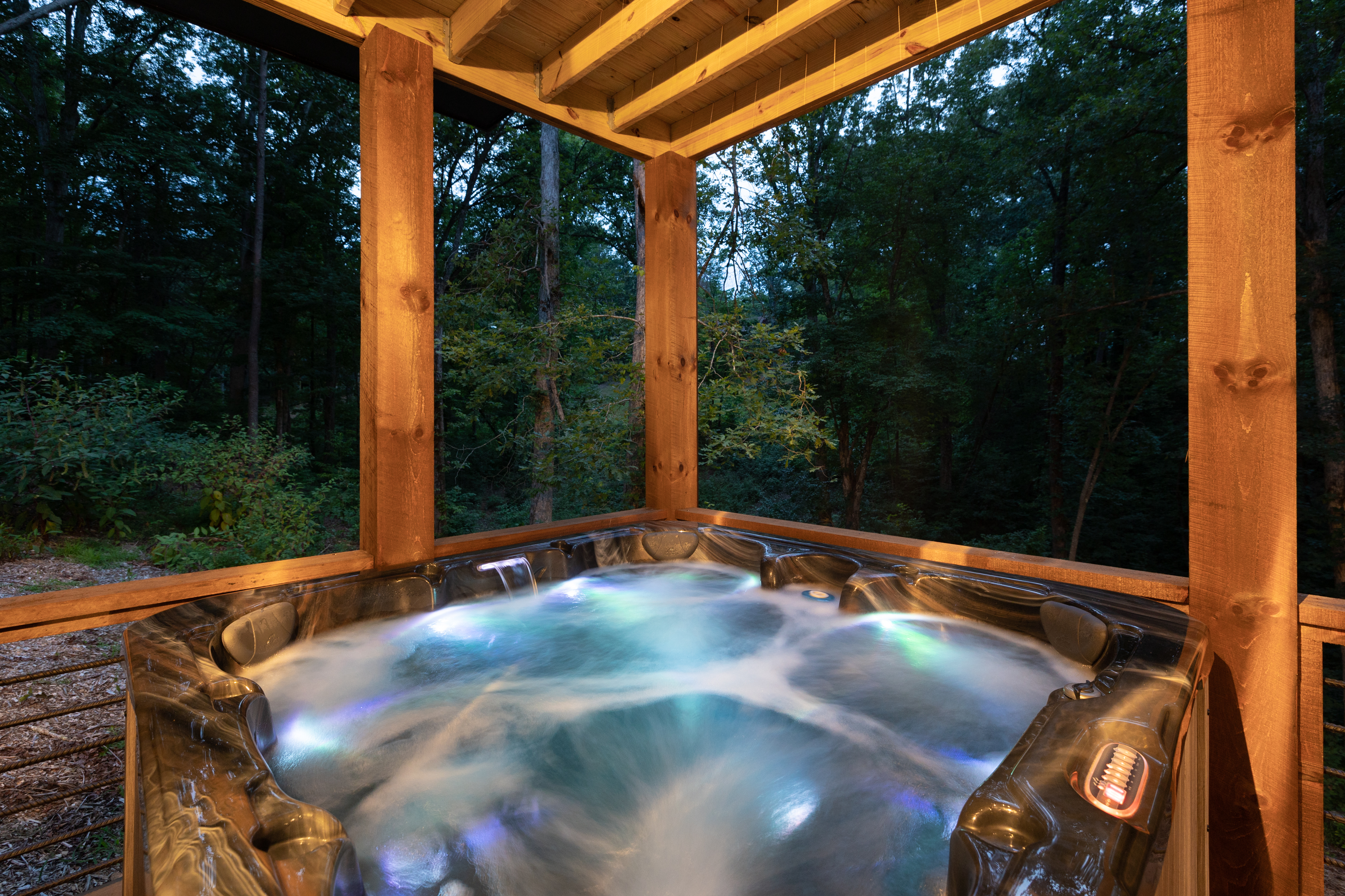 The hot tub is on the lower deck and views the back yard/woods. Hot Tub towels are provided as well to use during your stay.  The lower level deck also has a bench for sitting, towel hooks, and rocking chairs. Lower deck enters the game room in basement.