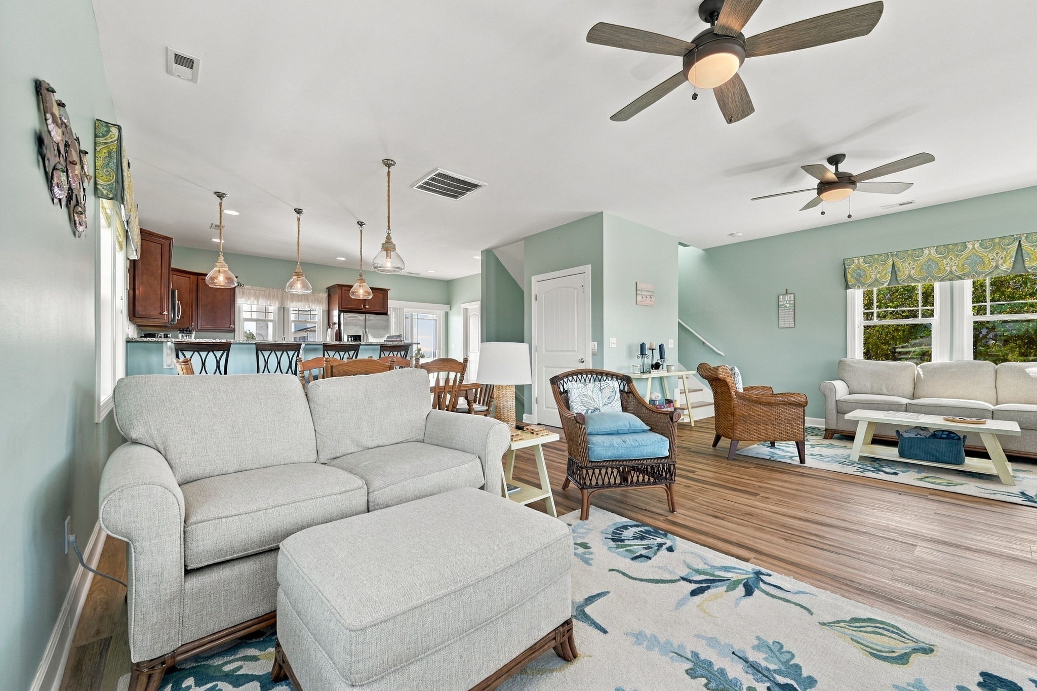 Kick back and relax in the spacious living room featuring plush seating, cheerful coastal décor, and room for everyone to gather