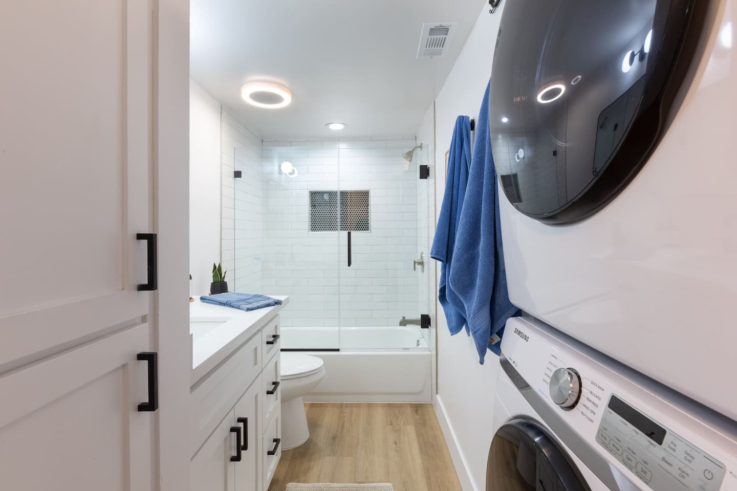 Full size stackable washer and dryer in newly remodeled second bathroom.  