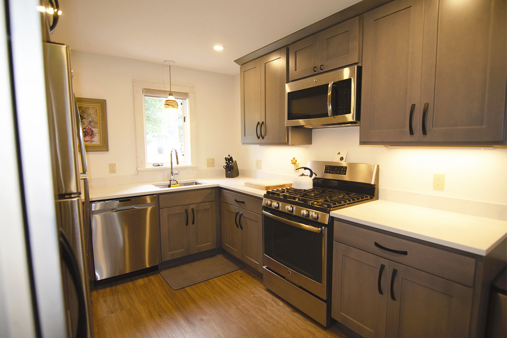 Newly remodeled kitchen and appliances. Built-in - side-by-side refrigerator, dishwasher, microwave/fan/light, oven and cooktop.