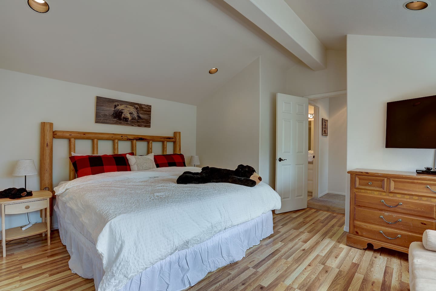 This large primary bedroom has plenty of space for a king bed plus a twin bed for lounging or extra sleeping space. It features a walk-in closet and an en-suite bathroom. The primary bedroom also features a TV with ChromeCast and blu-ray. 