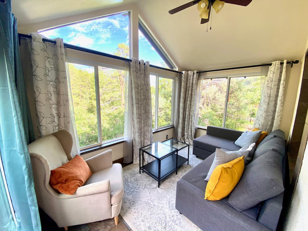 Sunroom located off the living room.  This is perfect for relaxing in a quiet space with a view of the outside! The sofa pulls out to a queen size bed for additional sleeping for 2.