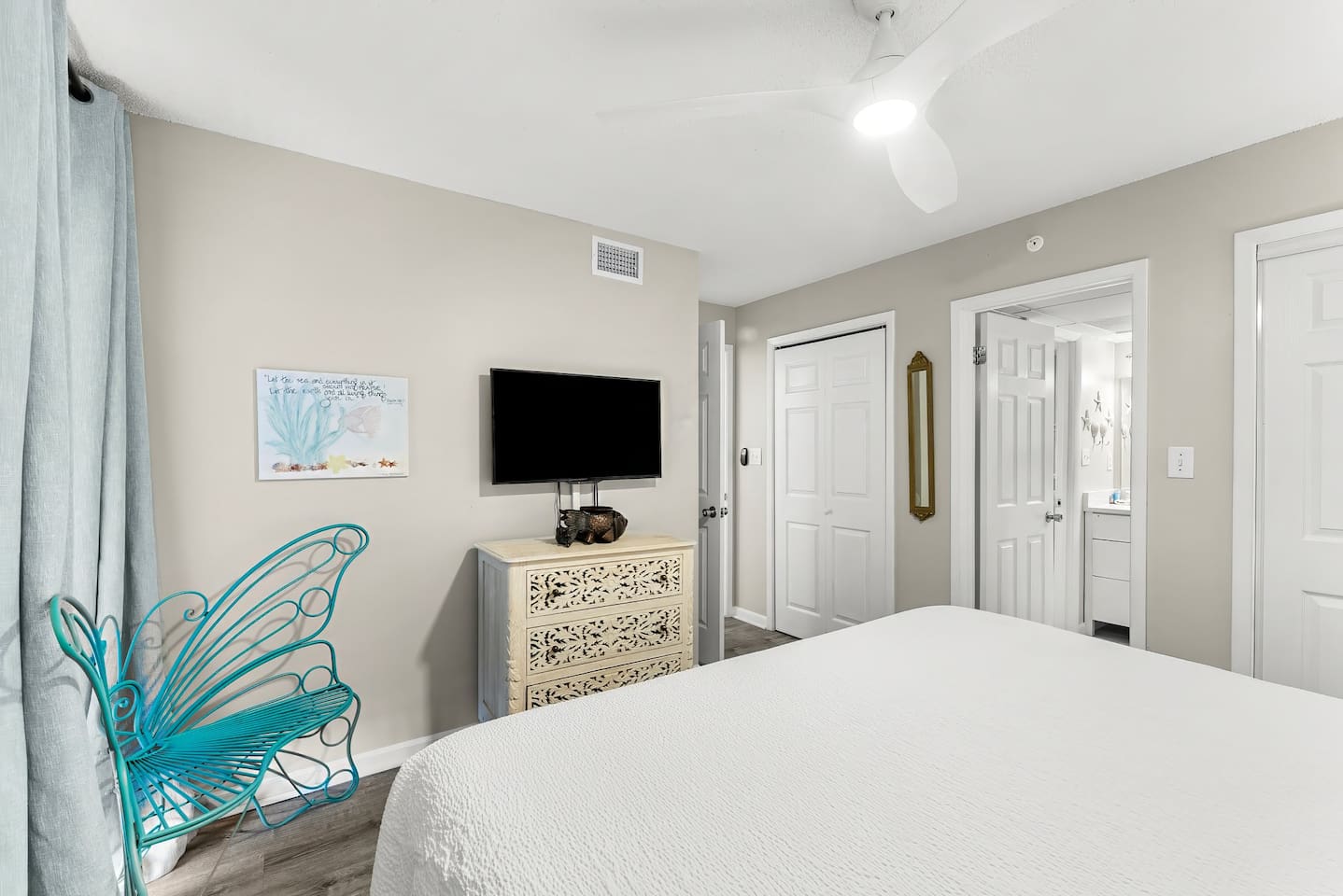 King bedroom with ceiling fan and ensuite bathroom