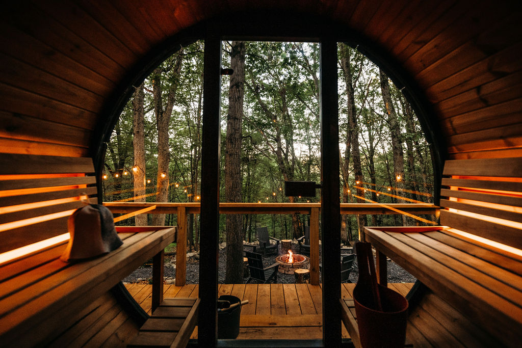 Private barrel sauna overlooking firepit