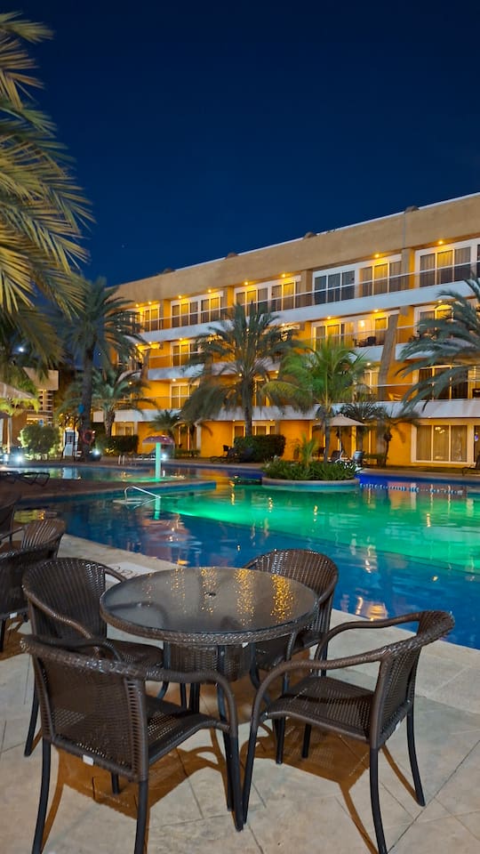 Relax by the illuminated pool. Perfect for a peaceful evening outdoors.
