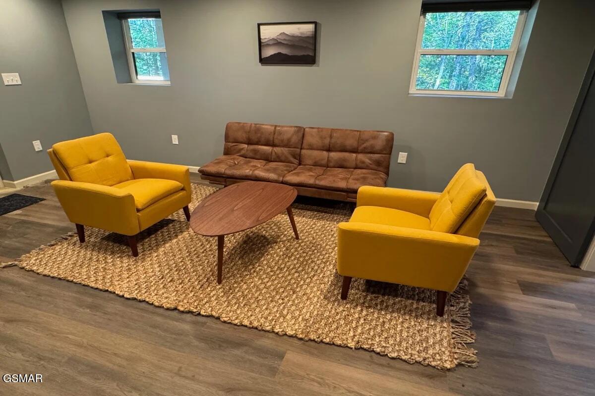 Love the retro vibe! Sink into this cool space in the game room for quiet conversations. Features a unique wooden coffee table and forest views.