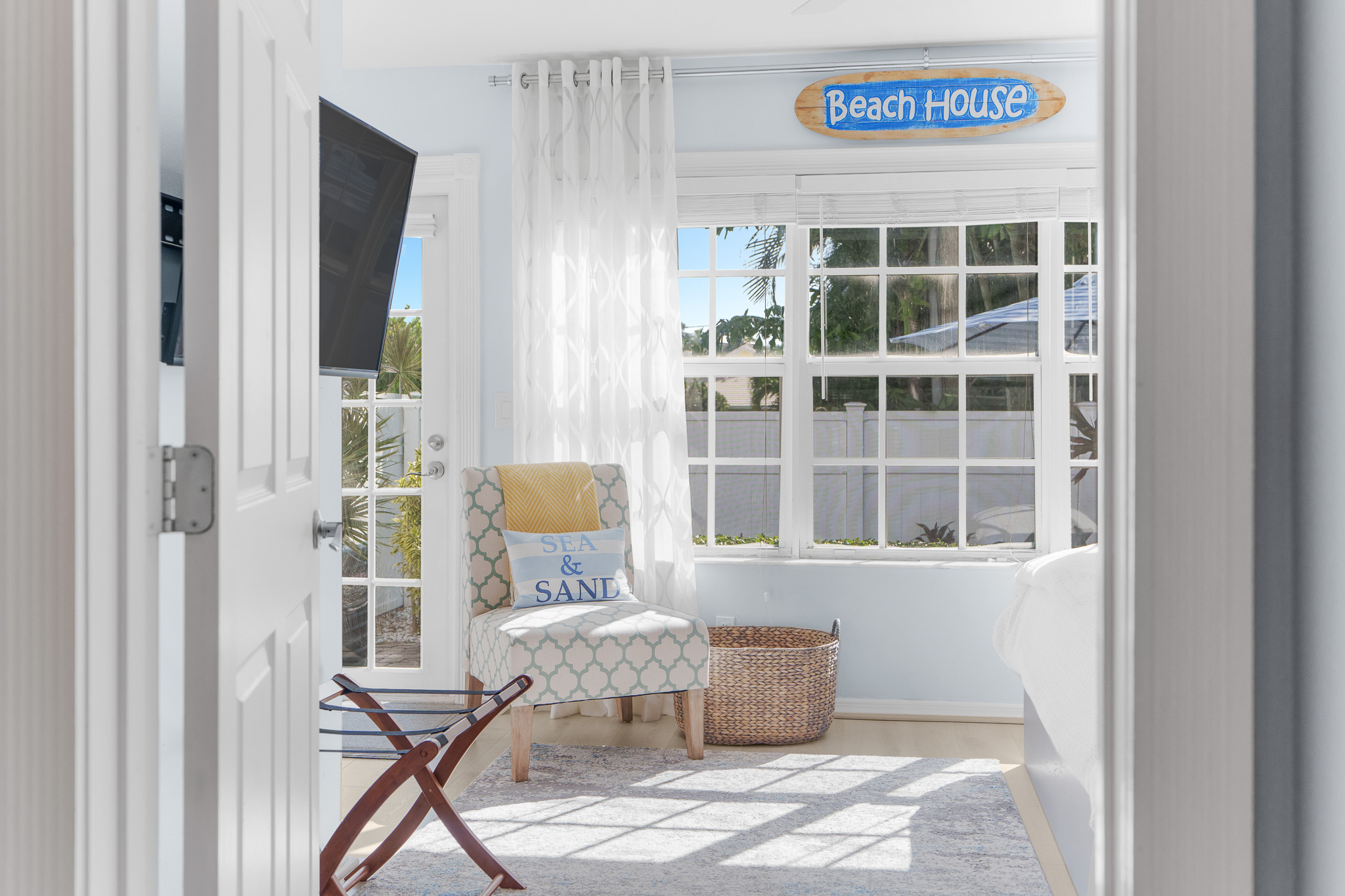 Master suite, with luggage rack, flat screen TV, and back patio access