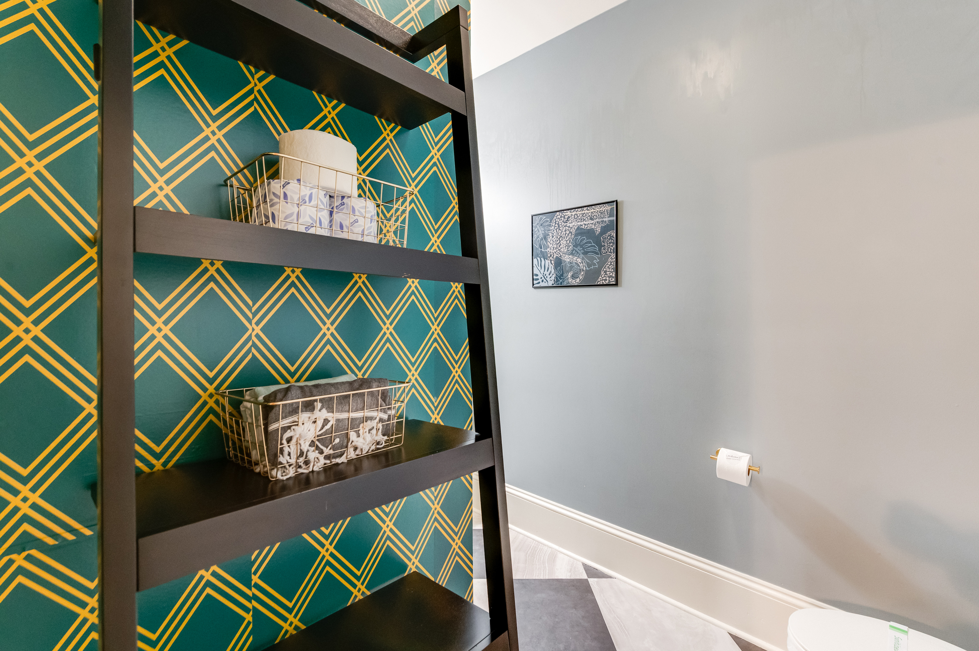 Ensuite to BR2: Vibrant patterned walls and stylish shelving for a fun touch! 