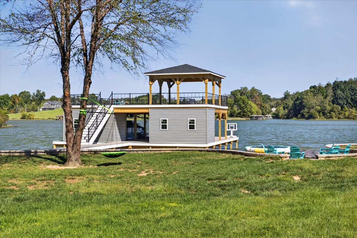 Impressive two-story boathouse with rooftop entertaining space and direct access to the sandy beach.