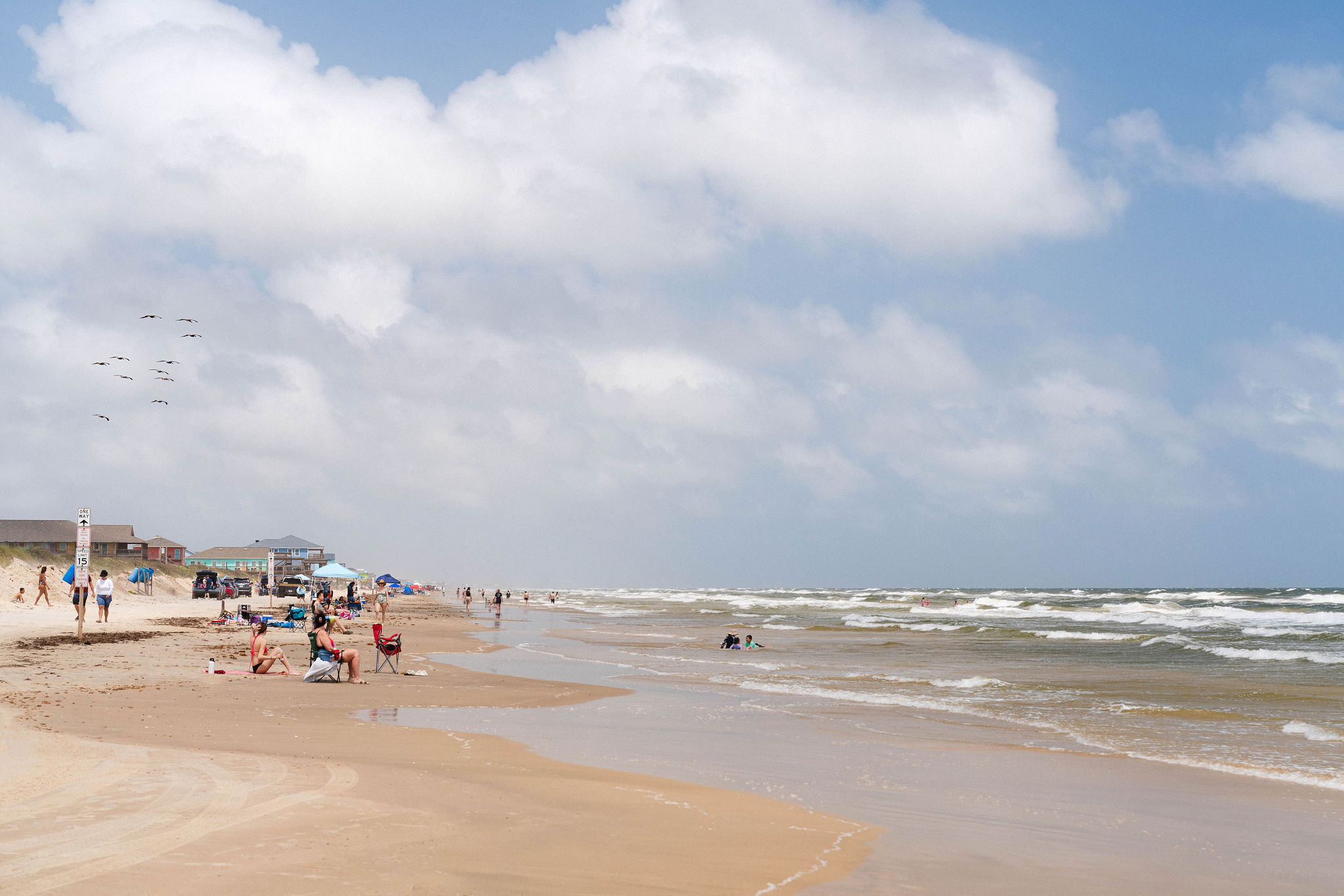 Typical summer day on Surfside Beach — lively but never crowded, plenty of sand for everyone.