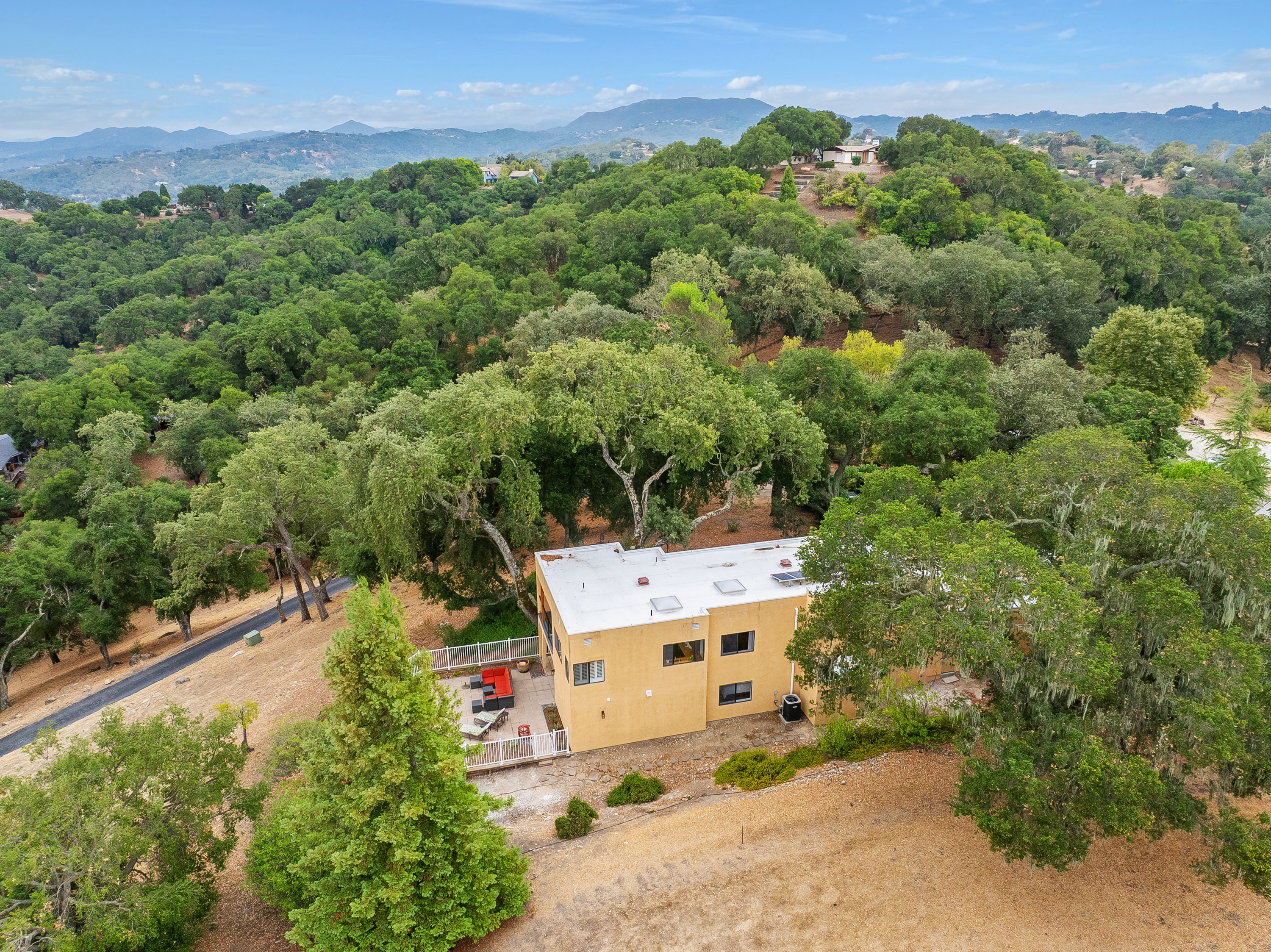 Modern hillside hideaway nestled in the treetops, with sweeping mountain views in every direction.