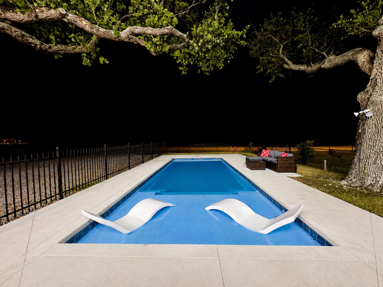 Relax poolside as the night sky sets a calming tone.