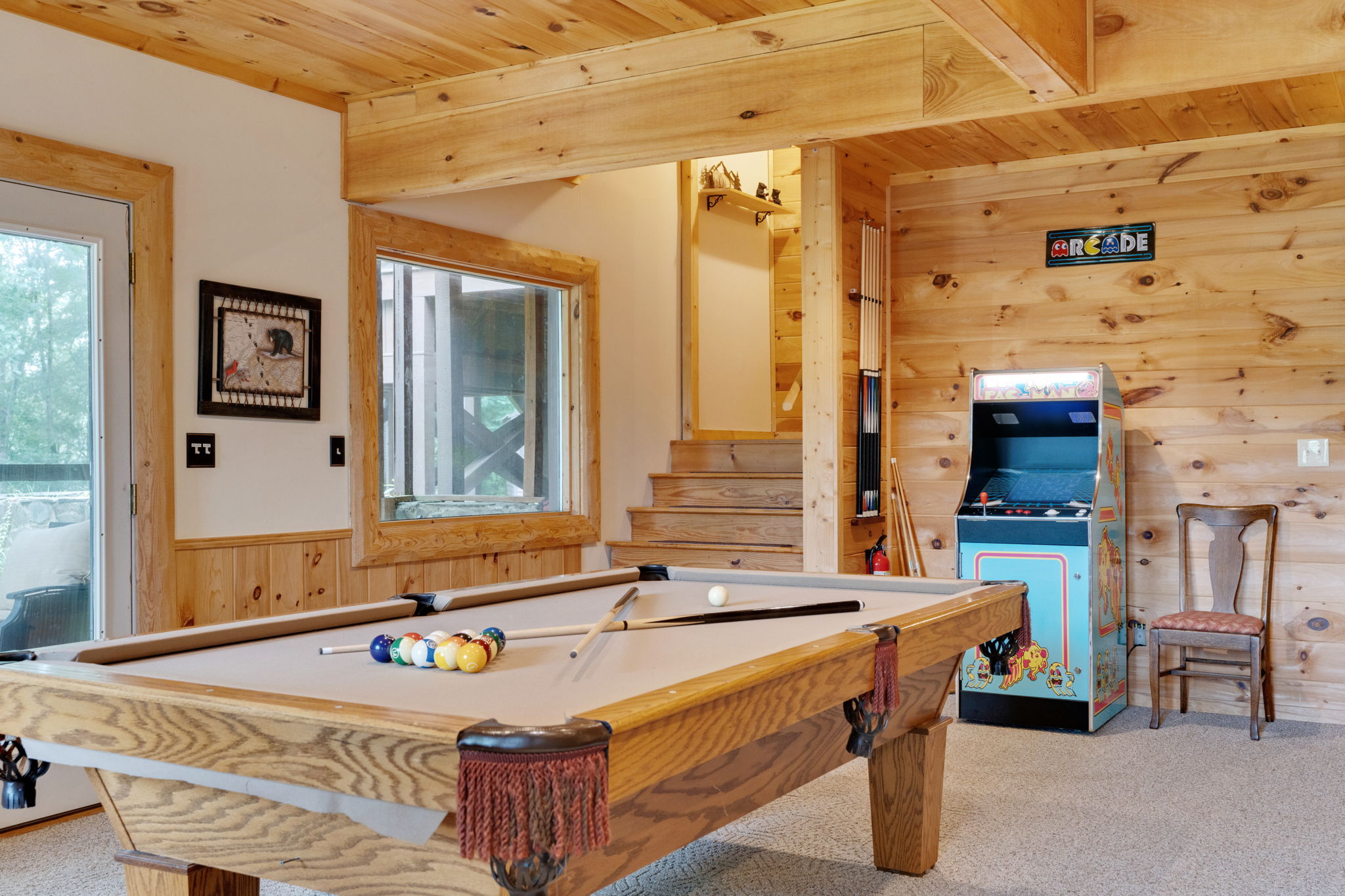Basement game room has pool table and classic arcade game with 60+ games.  Not shown is the pinball machine, sitting area and kitchenette.