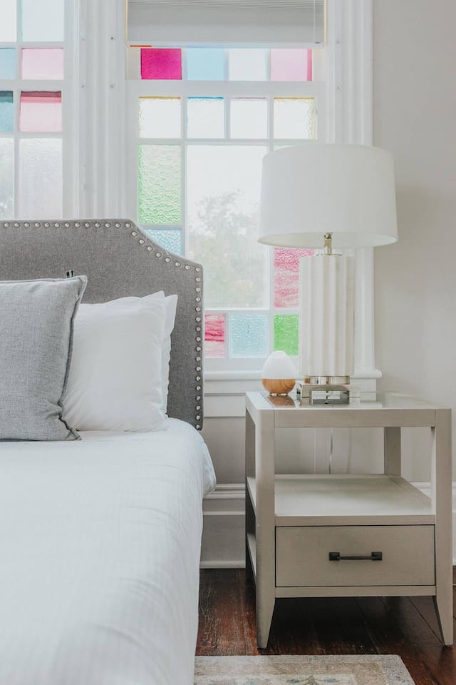 Primary bedroom with ensuite bath is truly a gem.  Stretch out on the king sized bed, enjoying the Savannah sunshine shining through the stain glass windows.  Located on one of the quieter blocks, you'll sleep until your heart's content.