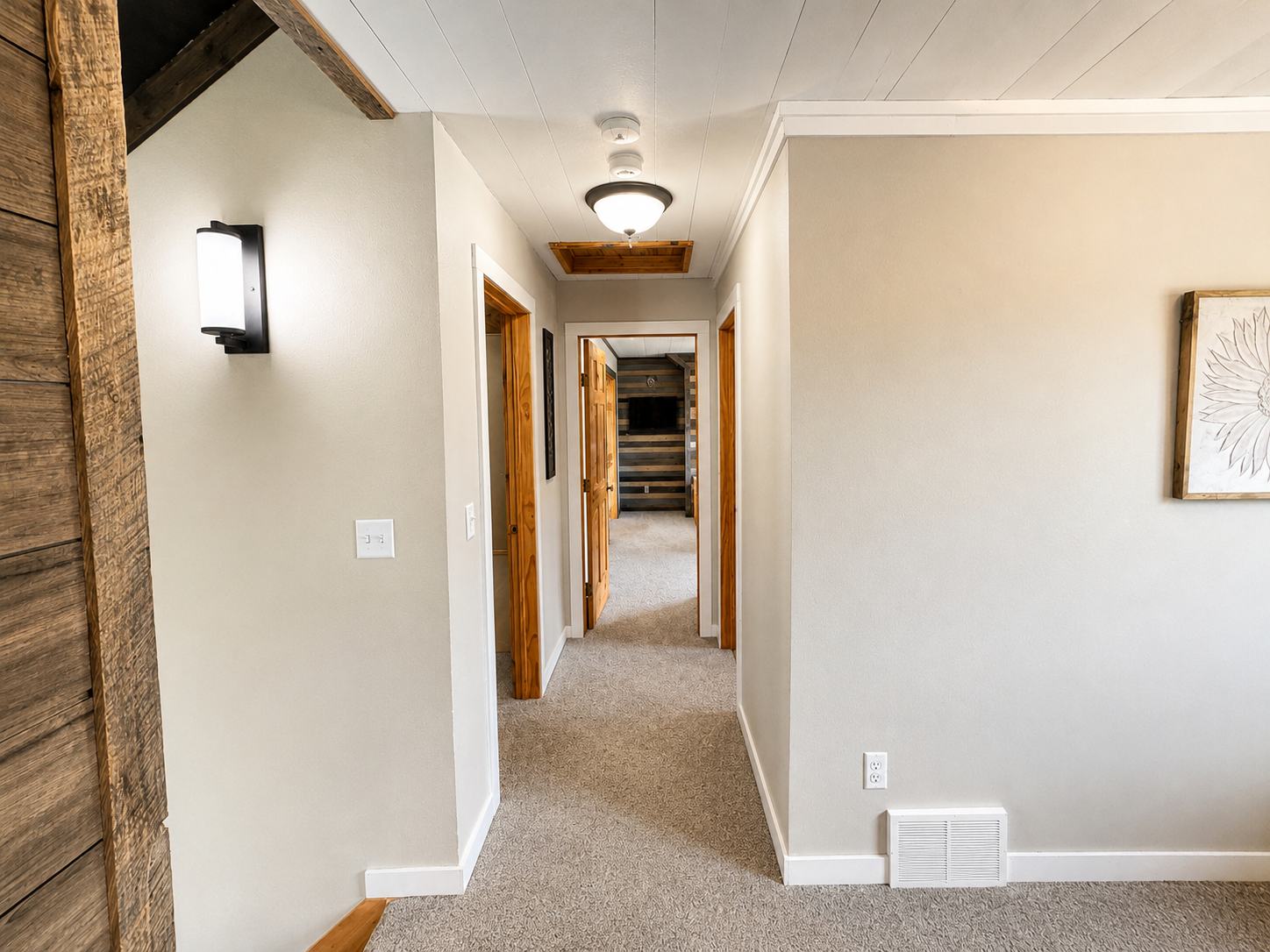 Off the steps the hallway connects two bedrooms and a bathroom. 
