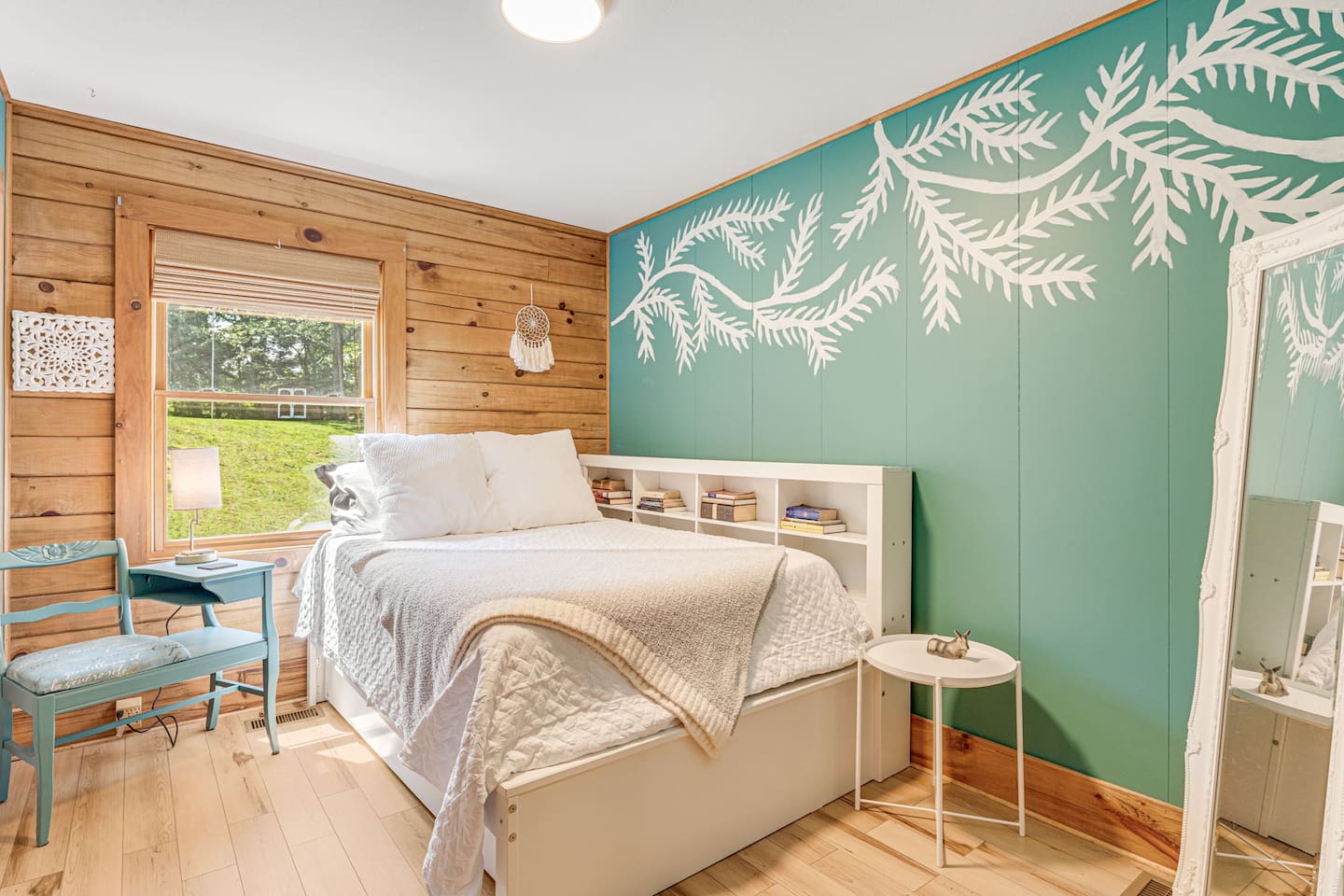 The main floor bedroom features a double mattress with a trundle bed underneath.