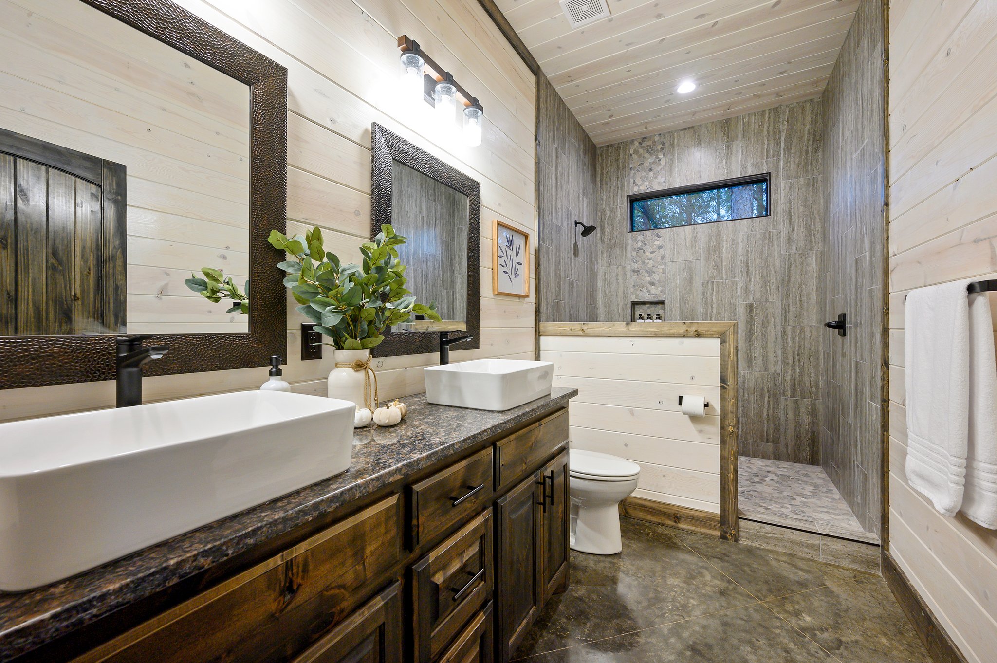 Unwind in style: A bright, modern bathroom with a private forest view.