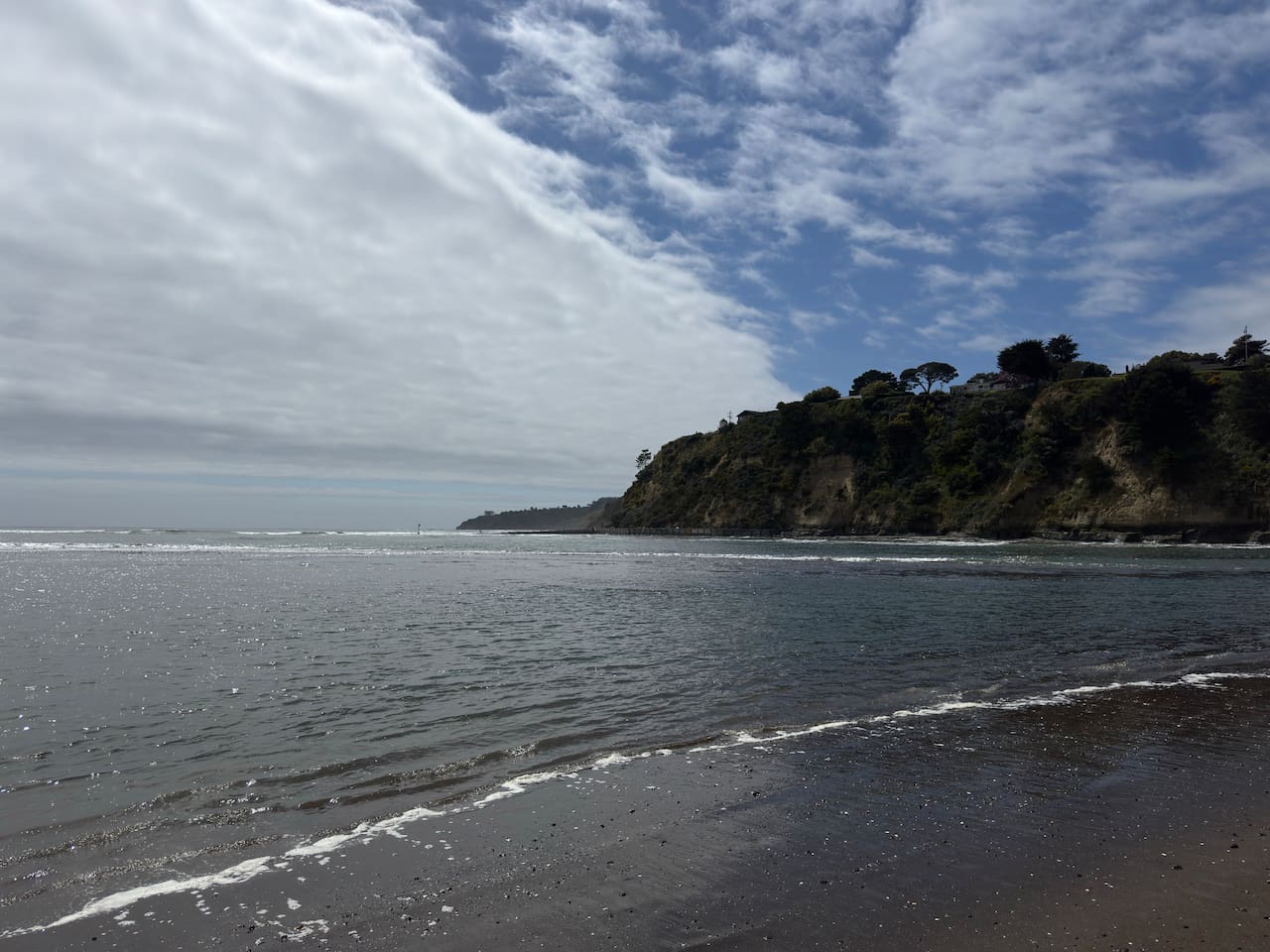Scenic ocean view from the shoreline at the cliff base.

