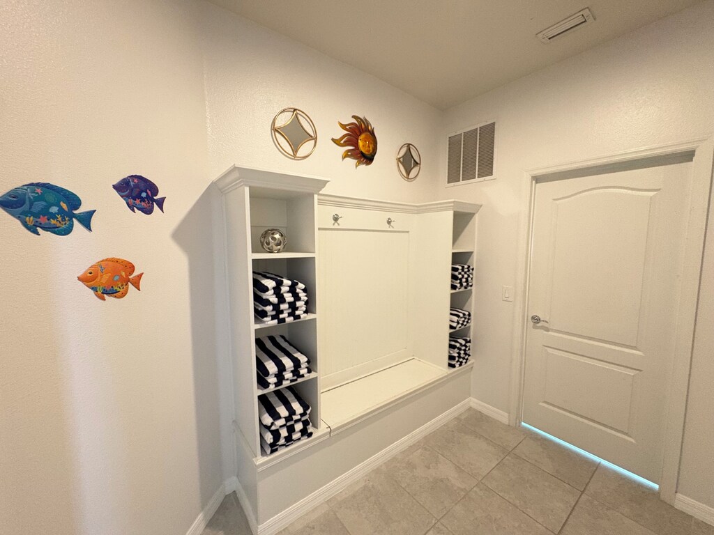 Lobby area with luxurious towels and sports equipment stored in the bench