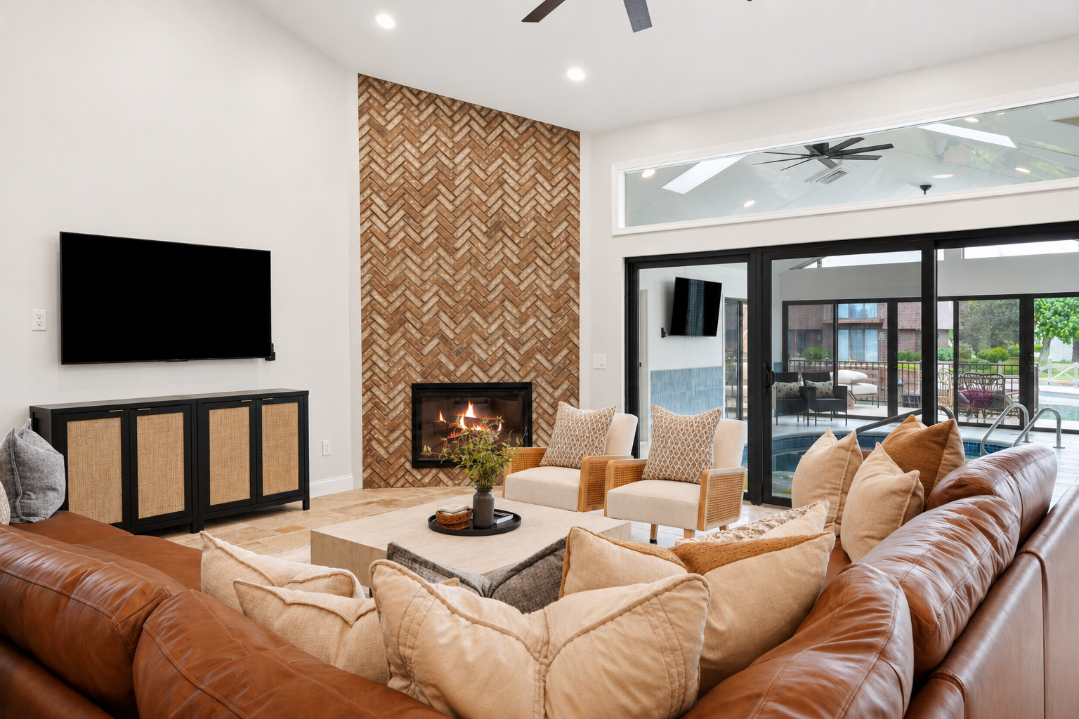 Spacious living room with a cozy sectional, modern fireplace, and open-concept layout. Bright, stylish space perfect for relaxing and gathering.