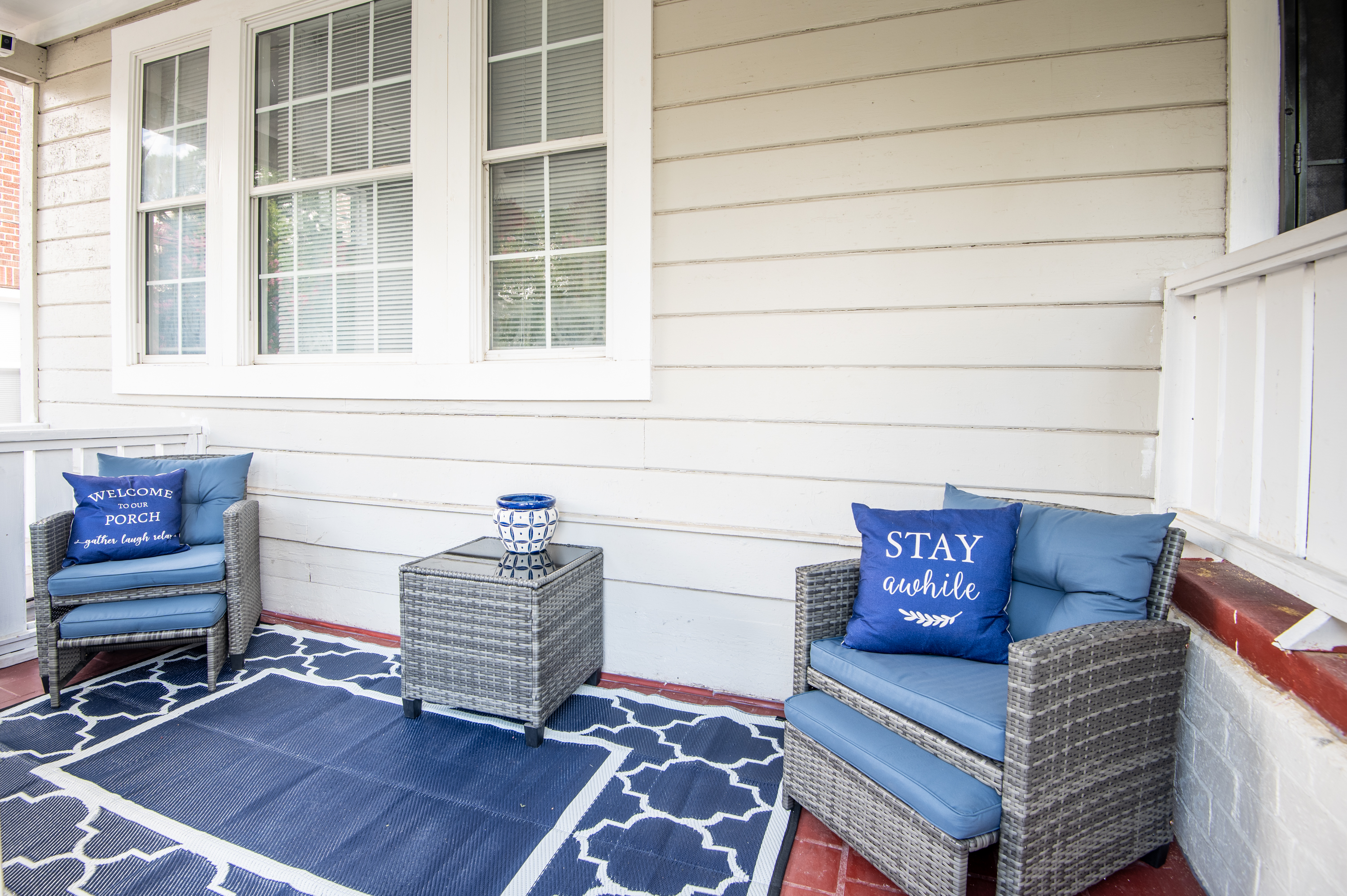 Unit B's inviting front porch with games and wooden stairs leading down to the unit.
