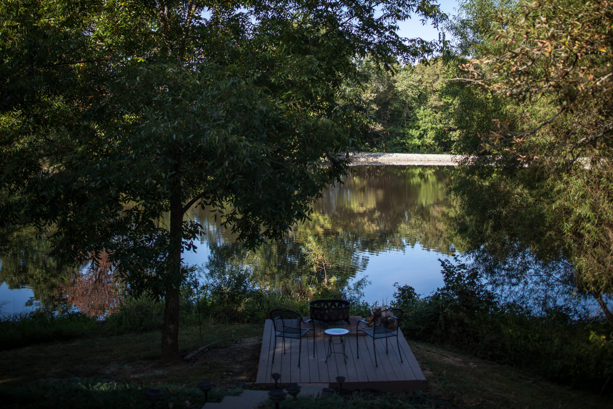 The wood fire pit overlooking the pond