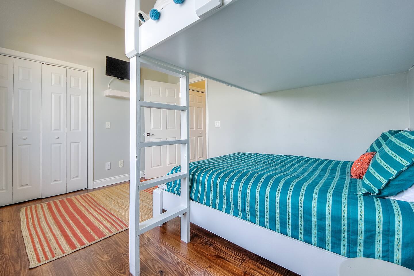 Another view of the teal striped bedroom. Love the fun orange accents!