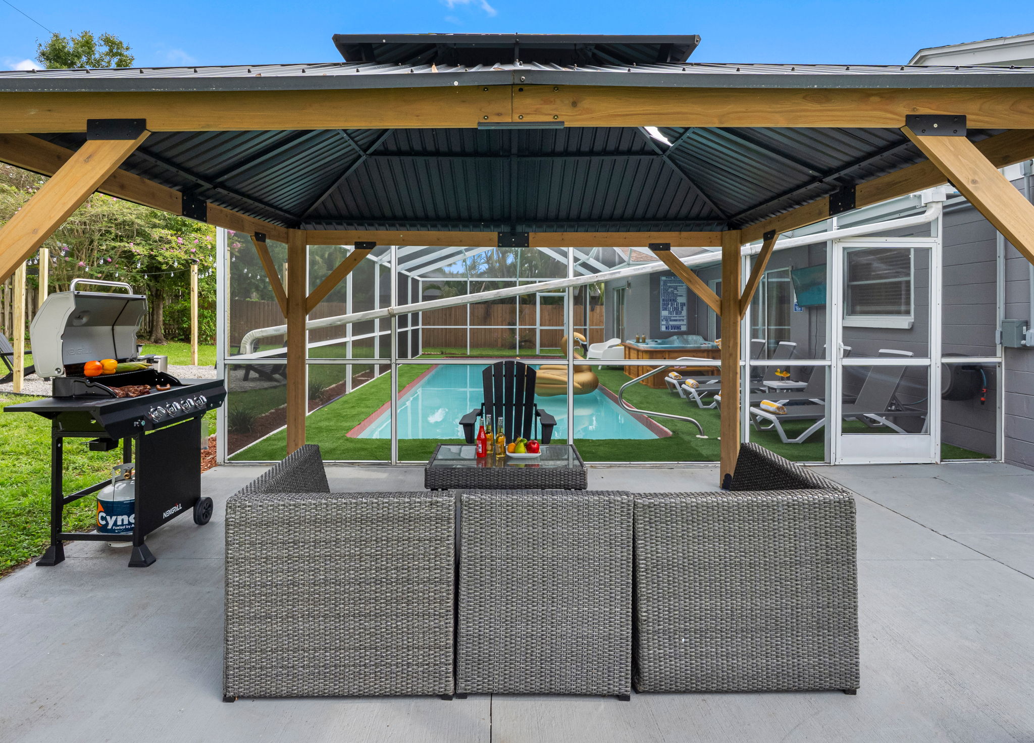 Grill with a view! Just steps from the pool, this space makes it easy to cook, relax, and connect—all in one beautiful setting.