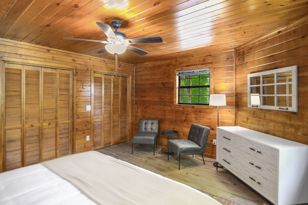 Upstairs bedroom w/ sitting area including two chairs -