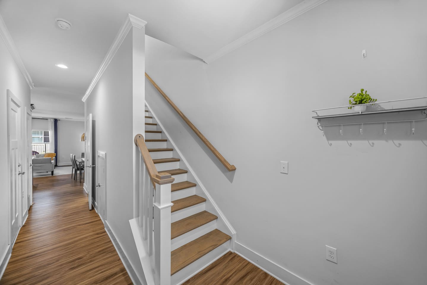 A warm welcome with wood flooring, bright walls, and easy access to the upstairs bedrooms.