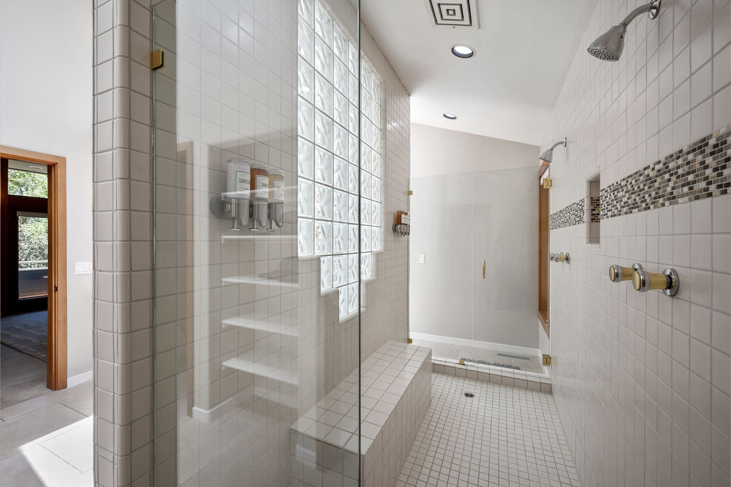 Primary bathroom shower has two entry doors with two independently-controlled showerheads.
