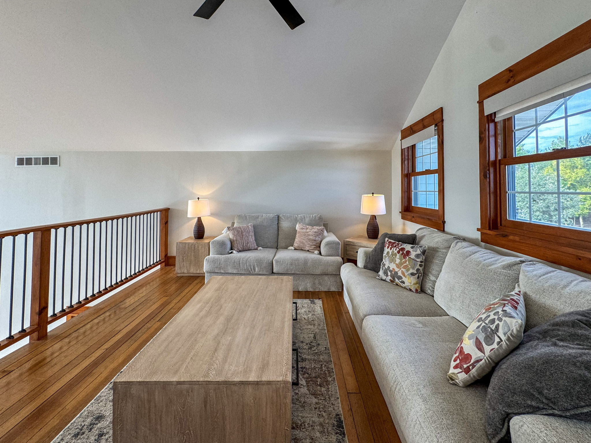 Loft above main living area with sleeper sofa and access to balcony on the front of the house