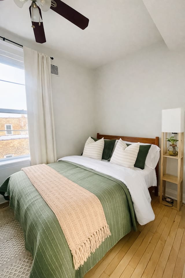 Comfortable Queen bedroom with soft linens and natural light.