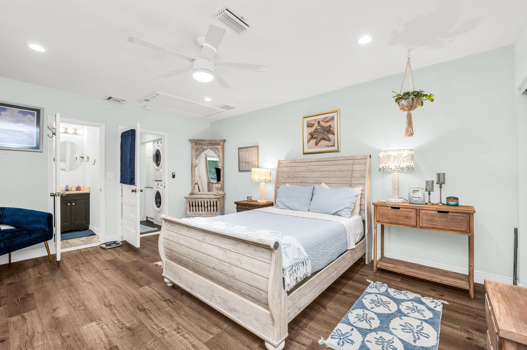 Spacious and peaceful master suite featuring a plush king bed, soft linens and elegant coastal decor.  Offering a cozy reading nook, and a calming palette - your private retreat for rest and relaxation.