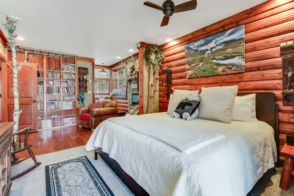 Primary bedroom with crisp bedding and peaceful forest views.