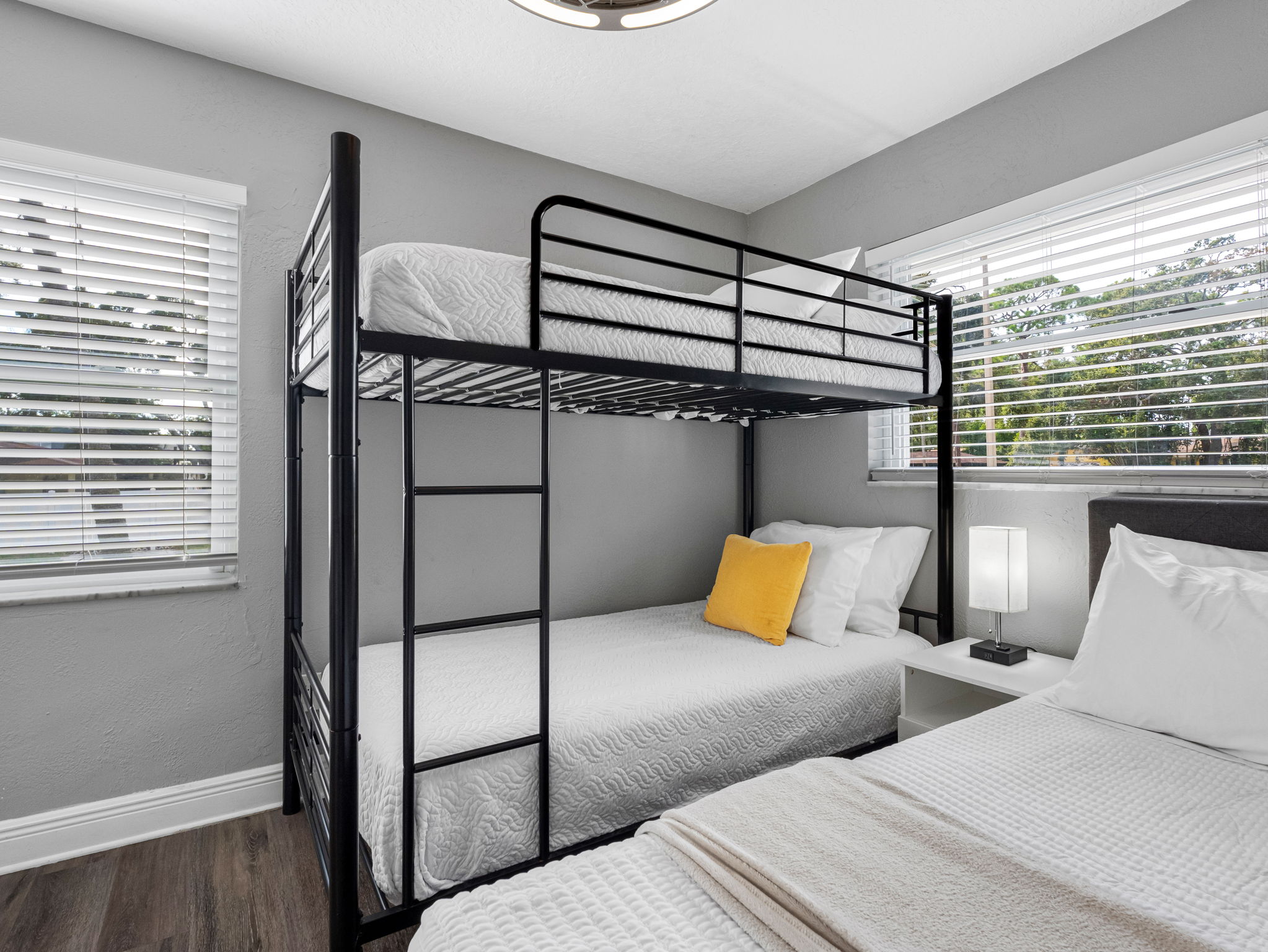 The playful vibe, modern bunk setup, and cheerful yellow accent pillows make this a hit with younger guests and teens alike.