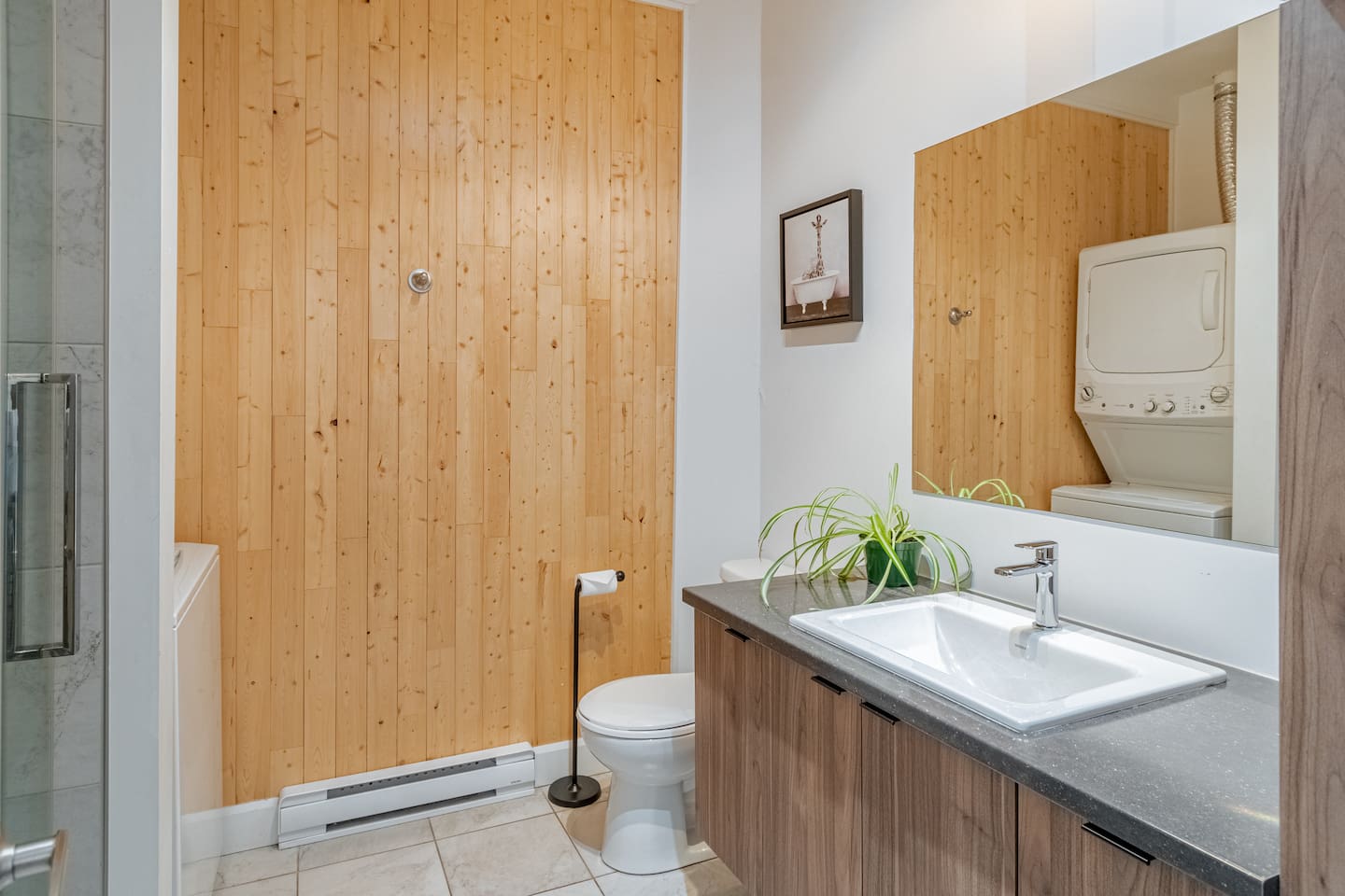 Salle de bain moderne et complète avec douche.