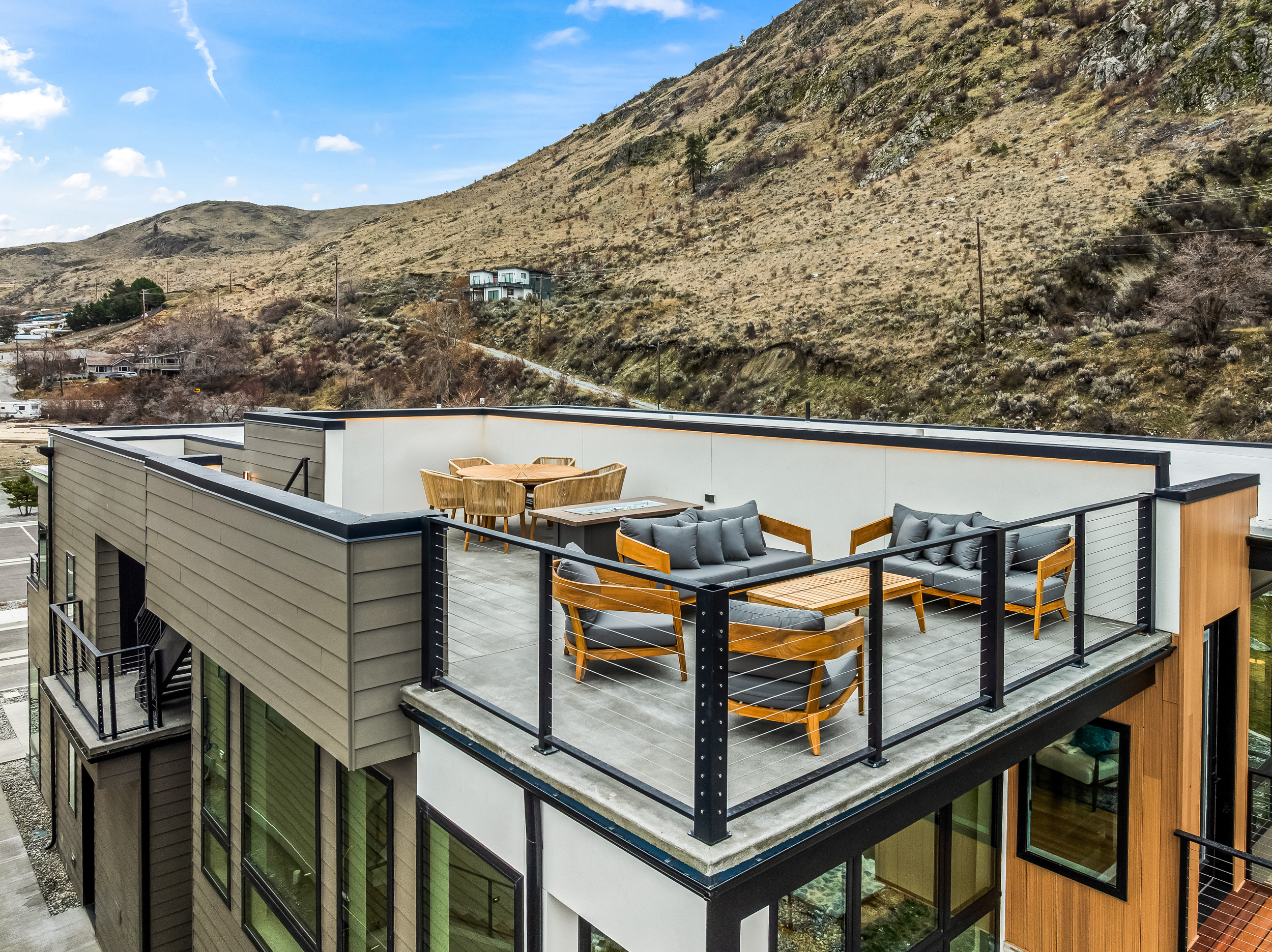 Rooftop deck with lounge seating, fire table and dining table