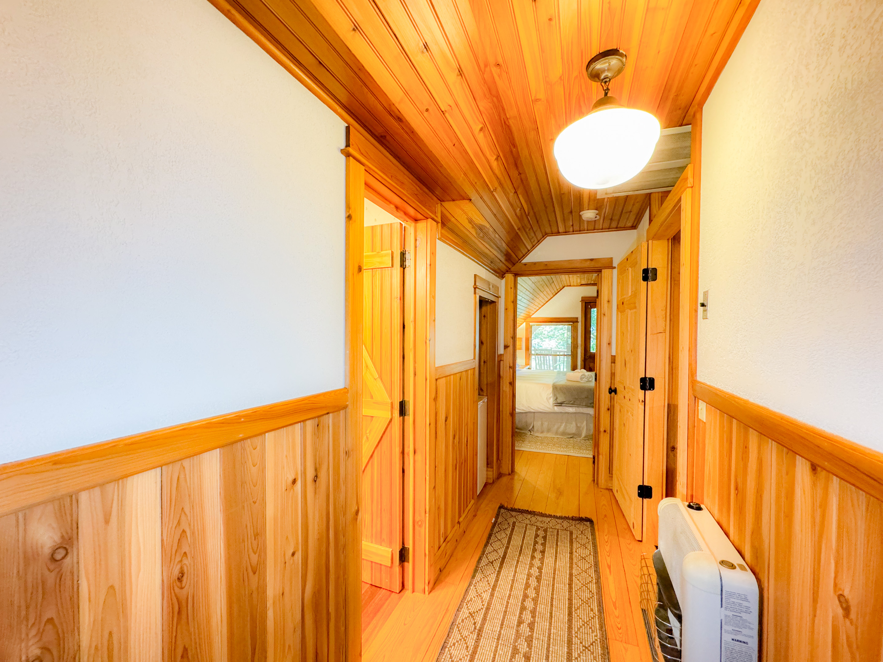 Hallway in the loft complete with a small refrigerator 