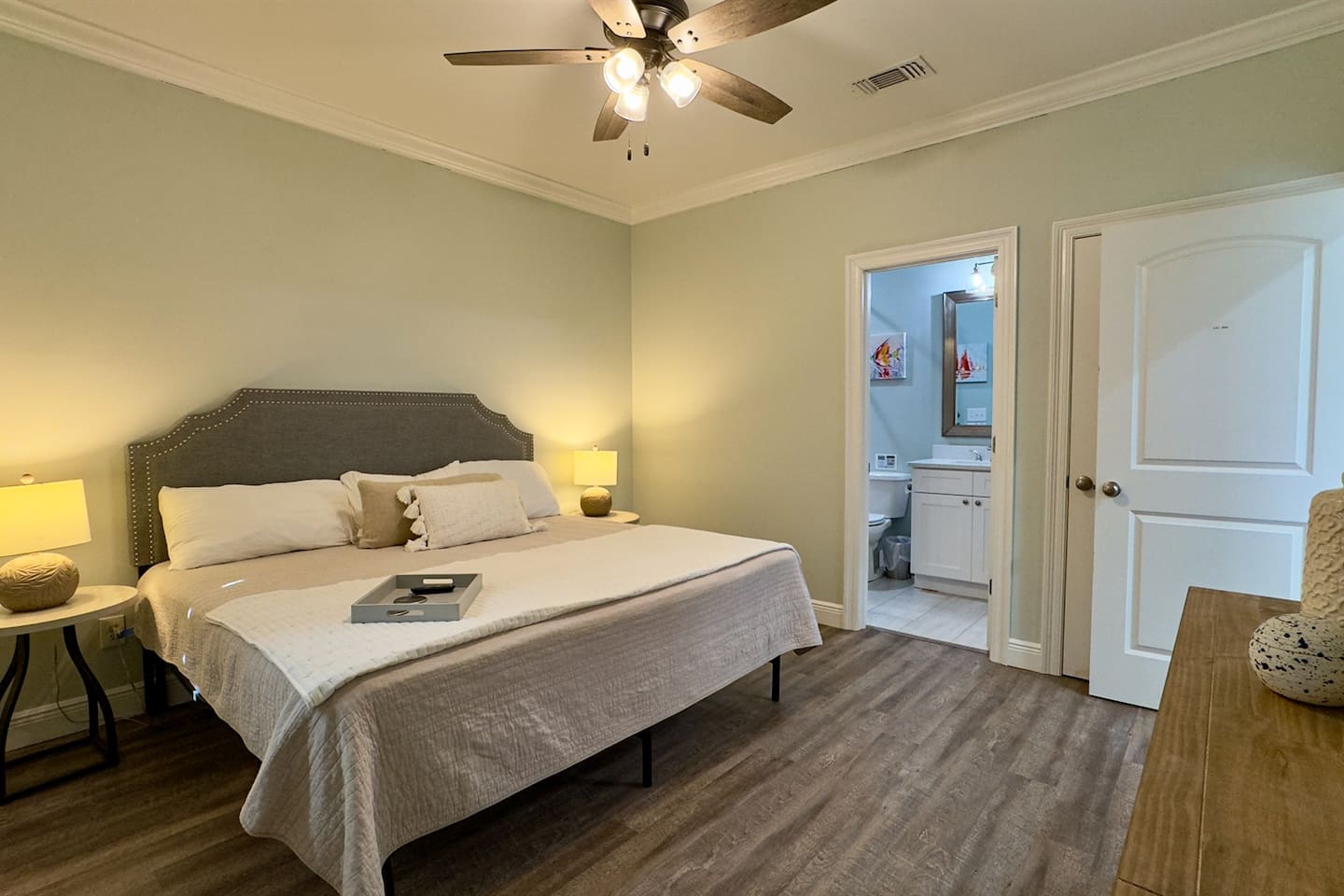 A bedroom that blends warmth, color, and functionality with its own ensuite bathroom.