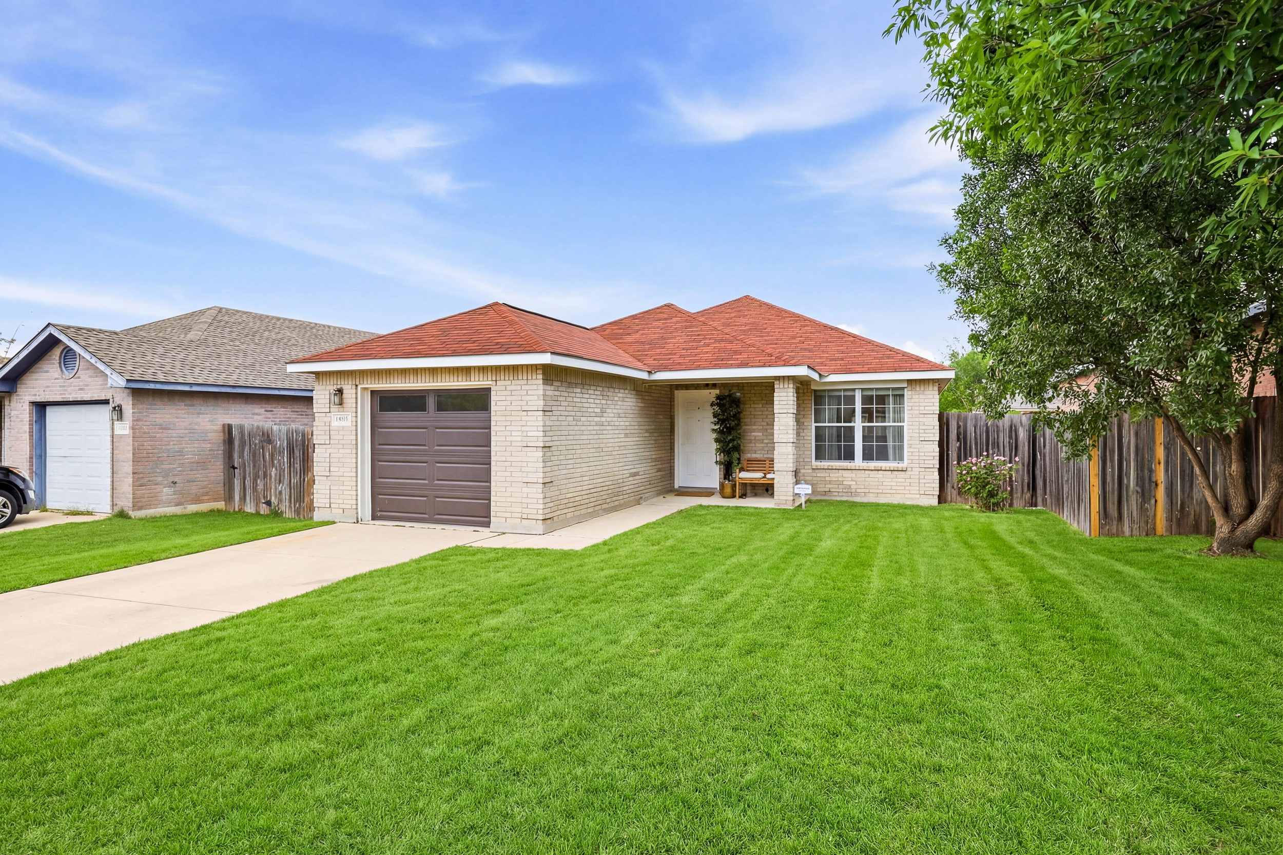 Spacious front yard with freshly cut grass, garage access, and covered entry. Fully fenced property in a peaceful Northwest San Antonio neighborhood near Culebra Road shopping and dining.