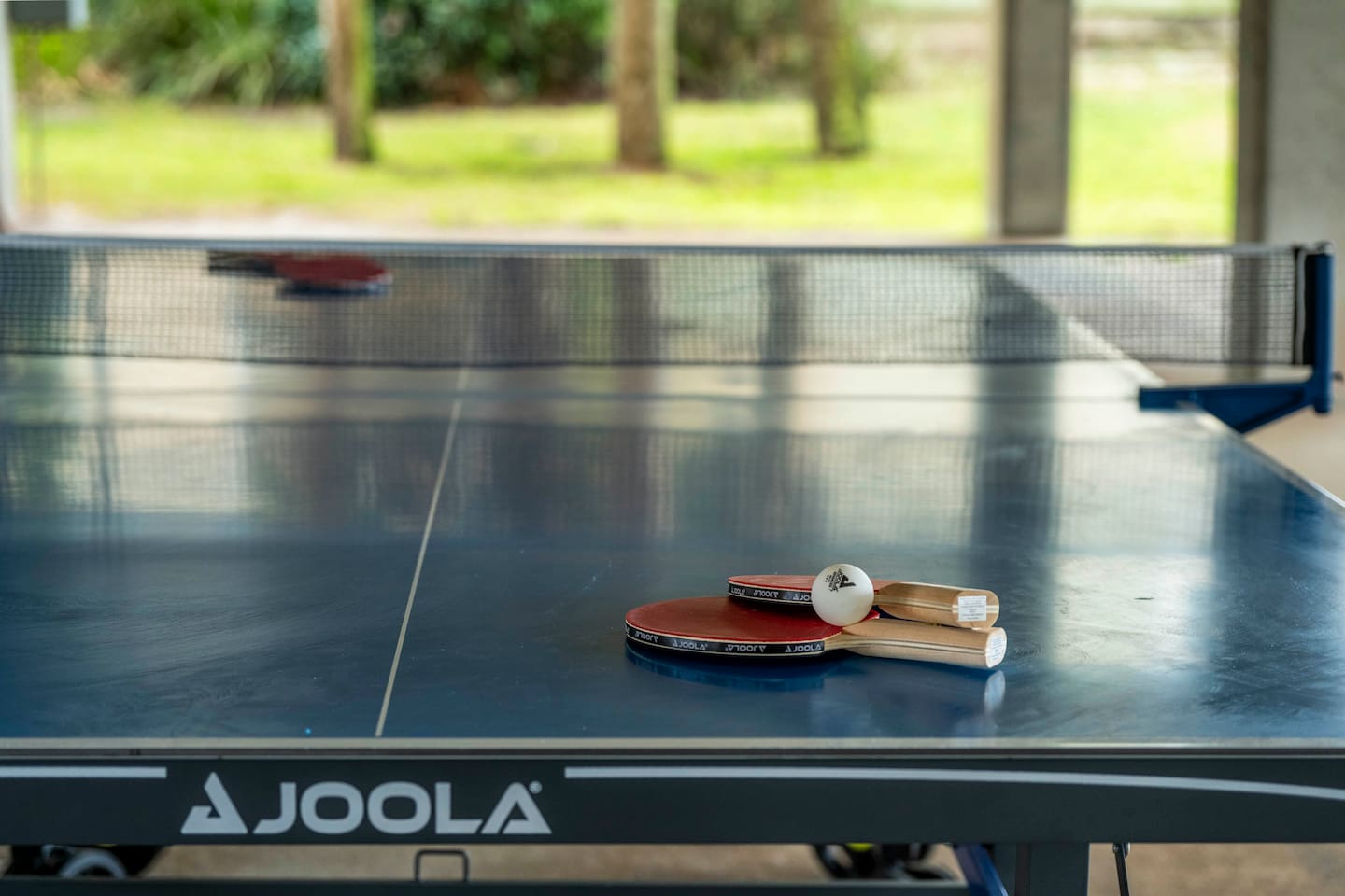 Ping pong fun: JOOLA paddles, ball, and table for outdoor table tennis excitement!