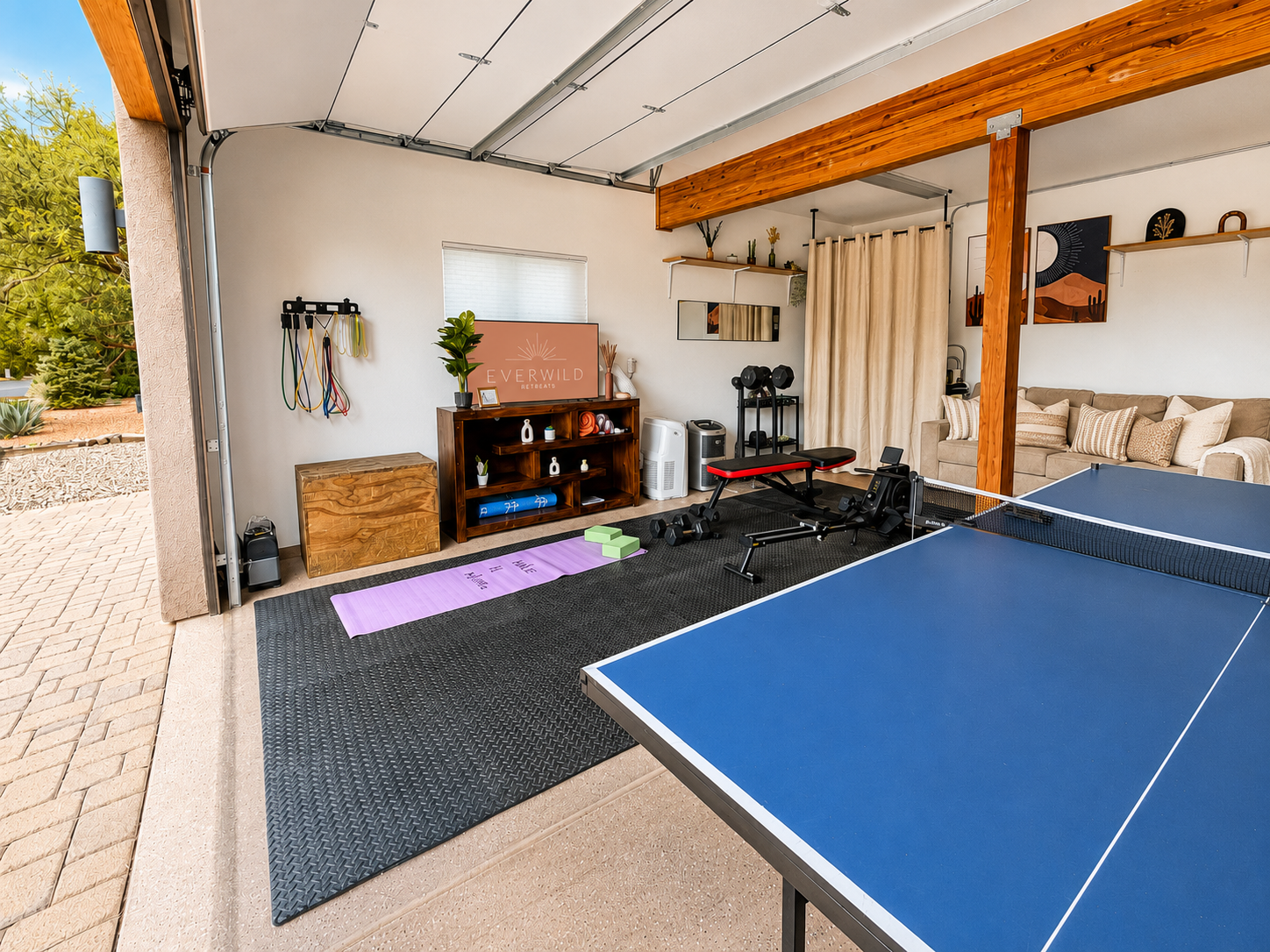 {CrossFit-Style Garage Gym + Game Room} Keep your routine going with 15–50 lb dumbbells, a rower, adjustable bench, resistance bands, yoga mats and blocks, plus plenty of open floor space—then challenge the group to a game of ping-pong.