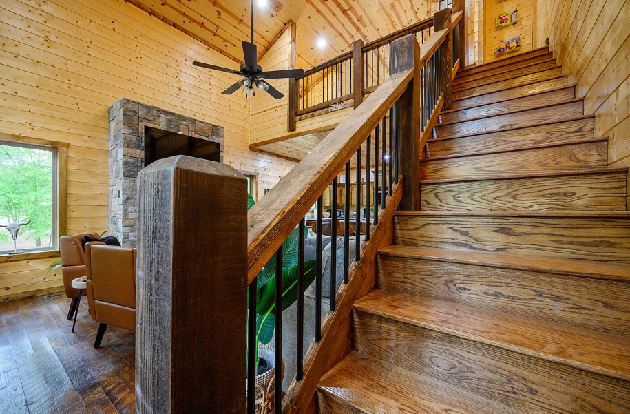 Beautiful handcrafted staircase adding rustic charm to the open cabin layout